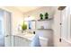 Stylish bathroom features a marble countertop, white cabinets, and decorative floating shelves at 9319 Harps Mill Ct, Charlotte, NC 28270