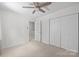 Bedroom with neutral carpet, walk-in closet, and a doorway to the hallway at 9319 Harps Mill Ct, Charlotte, NC 28270