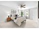 Bright bedroom features a ceiling fan, natural light, and tasteful decorations at 9319 Harps Mill Ct, Charlotte, NC 28270