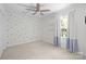Bedroom with neutral carpet, blue accents, and natural light through the window at 9319 Harps Mill Ct, Charlotte, NC 28270