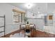 Charming dining area with seating for four, opening up to a screened-in porch and kitchen at 9319 Harps Mill Ct, Charlotte, NC 28270