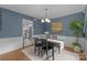 Well-lit dining room with hardwood floors and neutral walls, connecting to the kitchen at 9319 Harps Mill Ct, Charlotte, NC 28270
