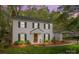 Charming two-story home with light siding, black shutters, manicured landscaping, and a detached carport at 9319 Harps Mill Ct, Charlotte, NC 28270