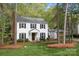 Traditional two-story home with manicured landscaping and a detached carport at 9319 Harps Mill Ct, Charlotte, NC 28270