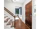 Bright foyer with hardwood floors, a staircase, and a solid wood front door at 9319 Harps Mill Ct, Charlotte, NC 28270