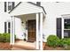 Inviting front entrance with stately columns, a charming front door, and manicured bushes at 9319 Harps Mill Ct, Charlotte, NC 28270