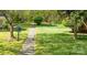 View of a greenway with grass and trees with a paved walking path at 9319 Harps Mill Ct, Charlotte, NC 28270