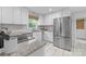 Contemporary kitchen with stainless steel refrigerator and updated countertops and cabinetry at 9319 Harps Mill Ct, Charlotte, NC 28270