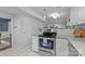 Modern kitchen with stainless steel oven, white cabinets, and a view into an adjacent living area at 9319 Harps Mill Ct, Charlotte, NC 28270