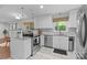 Well-lit kitchen with white cabinets, stainless steel appliances, and granite countertops at 9319 Harps Mill Ct, Charlotte, NC 28270