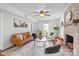 Spacious living room with a fireplace, hardwood floors, and neutral wall colors at 9319 Harps Mill Ct, Charlotte, NC 28270