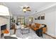 Inviting living room with brick fireplace, ceiling fan, hardwood floors, and modern decor at 9319 Harps Mill Ct, Charlotte, NC 28270