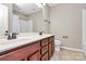 Bathroom boasts double vanity, matching mirrors, tile flooring and shower/tub combo at 9551 Glenburn Ln, Charlotte, NC 28278