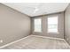This bedroom features natural light, a fan, and neutral walls at 9551 Glenburn Ln, Charlotte, NC 28278