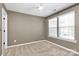 Neutral bedroom featuring bright natural light, a fan, and neutral walls at 9551 Glenburn Ln, Charlotte, NC 28278