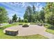 A community common area with sidewalks, benches and a well maintained lawn at 9551 Glenburn Ln, Charlotte, NC 28278
