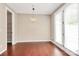 Bright dining room featuring hardwood floors, a modern light fixture, and natural light at 9551 Glenburn Ln, Charlotte, NC 28278