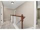 Hallway boasts wood banister and neutral walls and carpet at 9551 Glenburn Ln, Charlotte, NC 28278