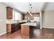 Modern eat-in kitchen featuring a center island, stainless steel appliances, and hardwood flooring at 9551 Glenburn Ln, Charlotte, NC 28278