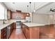 Gourmet kitchen featuring a center island, stainless steel appliances, hardwood flooring, and pendant lighting at 9551 Glenburn Ln, Charlotte, NC 28278