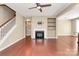 Bright living room featuring a fireplace, built-in shelves, and hardwood flooring at 9551 Glenburn Ln, Charlotte, NC 28278
