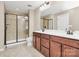 Main bathroom with dual sinks, tiled floors, and a glass-enclosed shower at 9551 Glenburn Ln, Charlotte, NC 28278