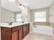 Bathroom with double sink, bathtub, and tile flooring at 9551 Glenburn Ln, Charlotte, NC 28278