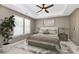 Serene main bedroom featuring a bed, ceiling fan, tray ceilings, and neutral decor at 9551 Glenburn Ln, Charlotte, NC 28278