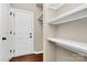Mud room with white door, white shelves, and hardwood floors at 9551 Glenburn Ln, Charlotte, NC 28278