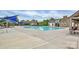 Community pool area with clear blue water, lounge chairs, and shaded seating at 9551 Glenburn Ln, Charlotte, NC 28278