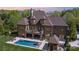 Aerial view of estate featuring a swimming pool, balcony, and lush landscaping at 1012 Shippon Ln, Waxhaw, NC 28173