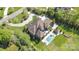 Aerial view of estate featuring a beautiful pool, cabana, and lush landscaping at 1012 Shippon Ln, Waxhaw, NC 28173
