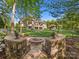 Expansive backyard with a fire pit, lush lawn, and beautiful landscaping creates a serene outdoor retreat at 1012 Shippon Ln, Waxhaw, NC 28173