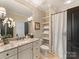 Bright bathroom with a granite-topped vanity, white cabinetry, and a shower-tub combination at 1012 Shippon Ln, Waxhaw, NC 28173