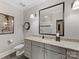 Elegant bathroom features a gray vanity with granite countertop, large mirror and modern fixtures at 1012 Shippon Ln, Waxhaw, NC 28173