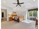 Inviting bedroom with a wood bed, a ceiling fan, and plenty of natural light from the windows at 1012 Shippon Ln, Waxhaw, NC 28173