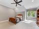 Cozy bedroom with a wooden bed frame, large window and view of the yard at 1012 Shippon Ln, Waxhaw, NC 28173