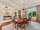 Elegant dining room with hardwood floors, a chandelier, large windows and views of the landscaped yard at 1012 Shippon Ln, Waxhaw, NC 28173