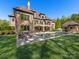 A luxurious brick home boasts a pool, patio, well-manicured lawn, and beautiful landscaping at 1012 Shippon Ln, Waxhaw, NC 28173