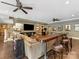 Spacious game room with custom bar, lounge seating, and ceiling fans for entertaining at 1012 Shippon Ln, Waxhaw, NC 28173