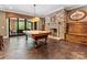 Large game room with pool table, stone fireplace, and outdoor access at 1012 Shippon Ln, Waxhaw, NC 28173