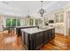 Large kitchen featuring double islands, hardwood floors, stainless steel appliances, and custom cabinetry at 1012 Shippon Ln, Waxhaw, NC 28173