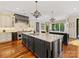 Spacious kitchen with double islands, hardwood floors, stainless steel appliances, and custom cabinetry at 1012 Shippon Ln, Waxhaw, NC 28173