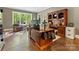 Executive office featuring custom wood built-ins and views of mature trees at 1012 Shippon Ln, Waxhaw, NC 28173