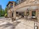 Covered outdoor living space includes a brick and stone fireplace and dining area at 1012 Shippon Ln, Waxhaw, NC 28173