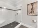 Walk-in shower with white subway tiles and a sleek glass door, enhancing the modern design at 1012 Shippon Ln, Waxhaw, NC 28173