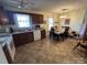 Eat-in kitchen with tiled floors, wood cabinets, and a ceiling fan at 112 Juanita Dr, Pineville, NC 28134