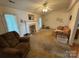 Living room with a decorative fireplace, neutral carpet, and lots of space at 112 Juanita Dr, Pineville, NC 28134