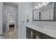 This bathroom features a sink with a decorative vanity, a large mirror and a view to the bedroom at 116 Jim Parker Rd, Wesley Chapel, NC 28110