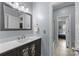 This bathroom features a sink with a decorative vanity, a large mirror and a view to the bedroom at 116 Jim Parker Rd, Wesley Chapel, NC 28110